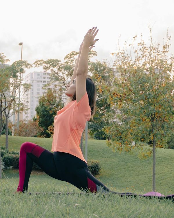 Woman in a calm yoga pose, embodying harmony and flexibility.